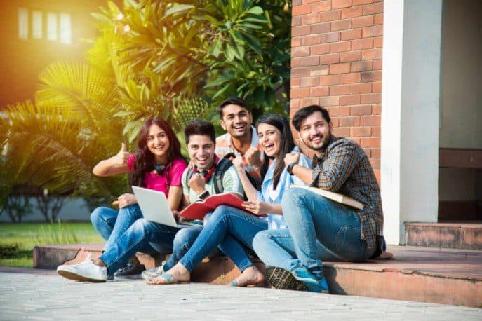 young-asian-indian-college-students-reading-books-studying-laptop-preparing-exam-working-group-project-while-sitting-grass-staircase-steps-college-campus (1) (1) (1) (1) (1)